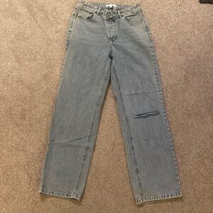 Distressed straight jean. Crossover snap button closure